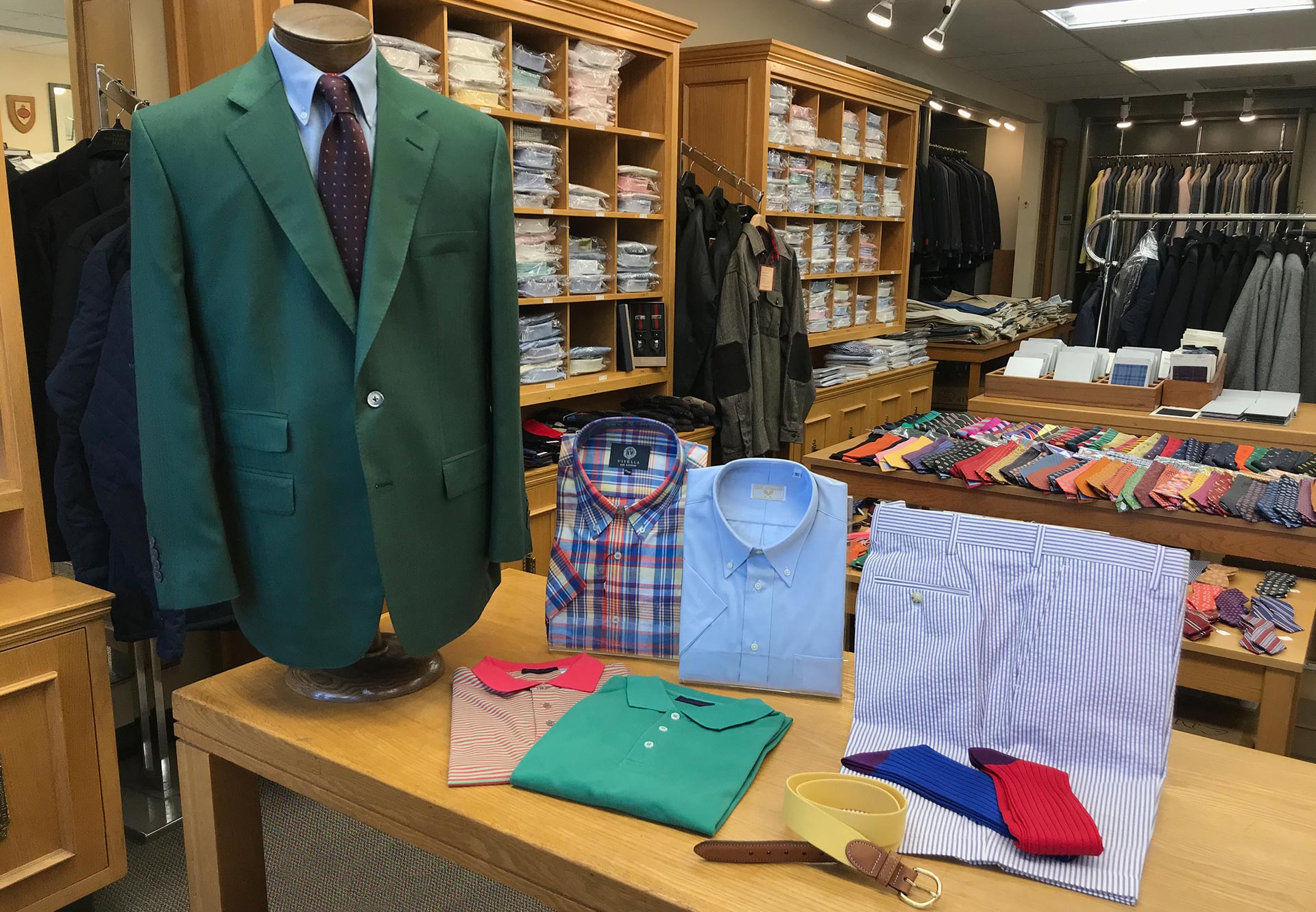 Store photo with green sport coat, short sleeve shirts, and seersucker shorts